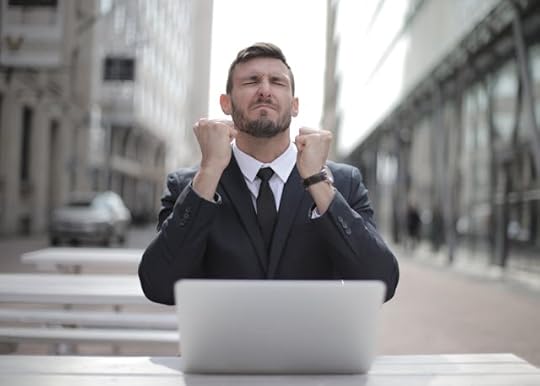 Man celebrating financial breakthrough after practicing daily money prayer