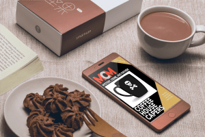MCM: Coffee House Capers on screen of cell phone in coffee shop