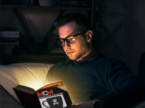 Man staying up late, reading MCM: Coffee House Capers