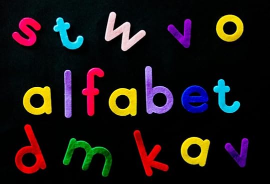 assorted color alfabet letters on black background