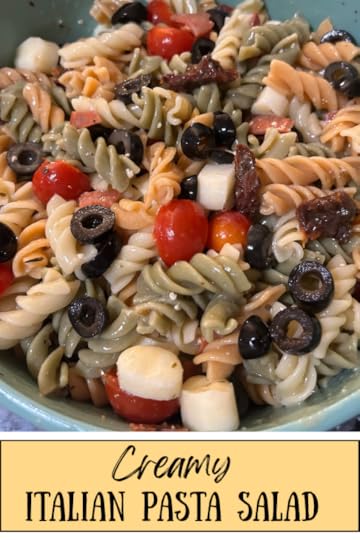 colorful pasta salad with rotini pasta and veggies, tossed in a bowl with dressing. Texas: Creamy Italian Pasta Salad (pin for pinterest)