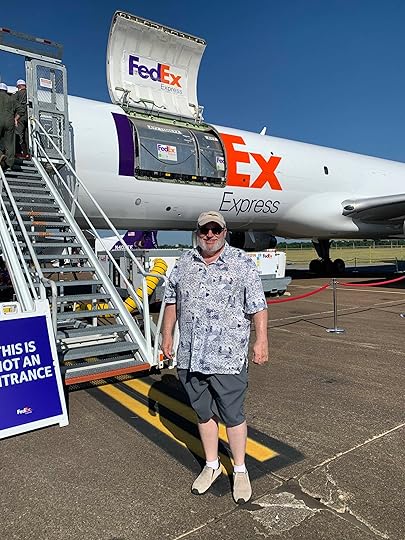 Man standing next to steps leading to the entrance of a FedEx cargo plane