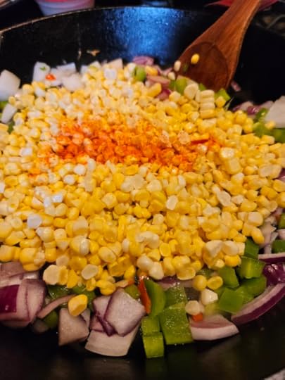 Corn and onions and peppers being made into a freezer side dish.