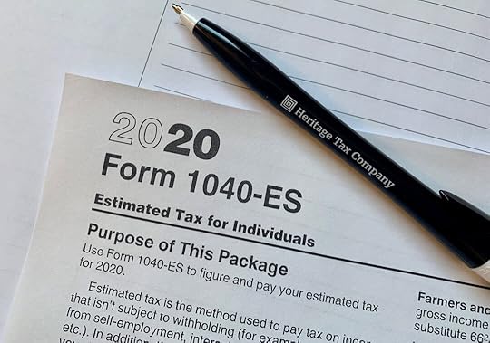a pen sitting on top of a tax form