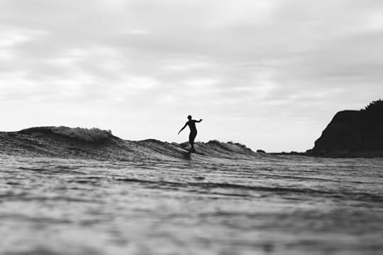 A surfer riding a wave. How do you balance what you desire to do with what you can do?