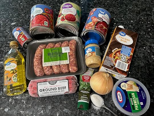 Sunday gravy ingredients: sauces, meats, broth, olive oil, spices, veggies