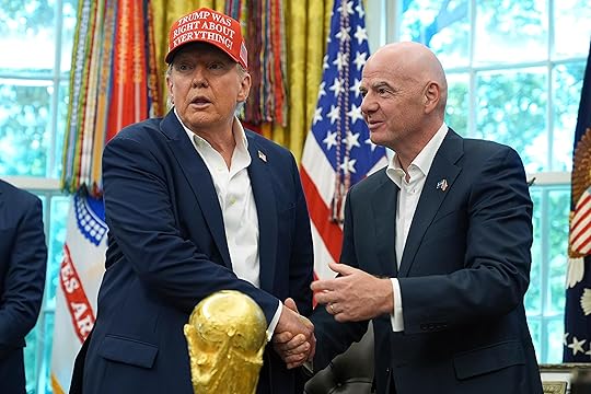 President Donald Trump, left, shakes the hand of FIFA President...