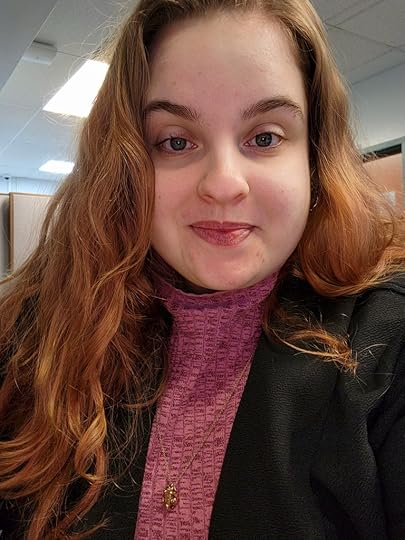 Photo of Samantha Zimmerman, with longer red-brown hair, facing the camera.