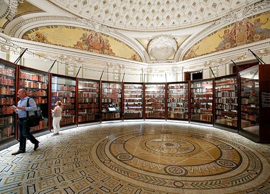 Tall wooden bookcases, formed into a circle and protcted by plexiglass, house Jefferson's book collection. A mosaic tile floor and an ornate domed ceiling make it a beautiful setting.