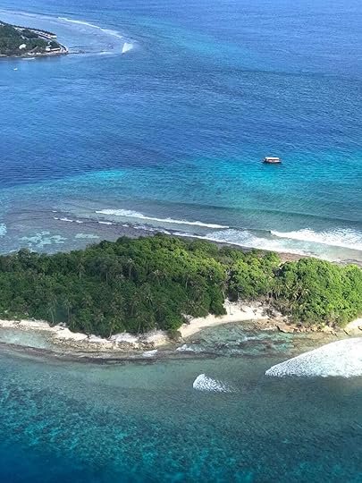 Aerial view ofMaldivian islands with a Dhoni, a traditional Maldivian vessel in the sea.