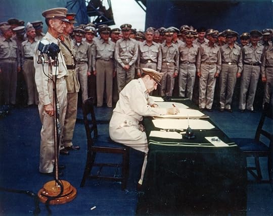 Gen. Douglas MacArthur signing the Japanese surrender documents aboard USS Missouri, 2 Sept 1945 (US National Archives: USA C-4627)