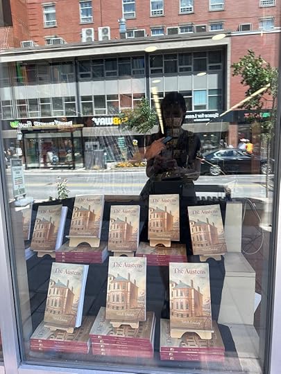 Window display with several copies of The Austens