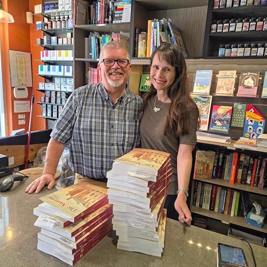 Mike Hamm and Sarah Emsley with two stacks of copies of The Austens