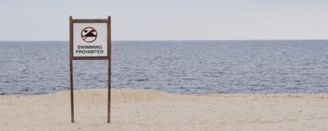 Beach with a sign that reads