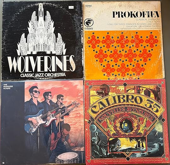 4 album sleeves: the Wolverines Classic Jazz Orchestra (but not the one you’re probably thinking of), an album of Prokofiev’s music (“Lt. Kijé Suite”, “Suite from Live for 3 Oranges”, “Classical Symphony “), an SP by the Fearless Flyers, “Nouvelles Aventures” by Calibro 35).