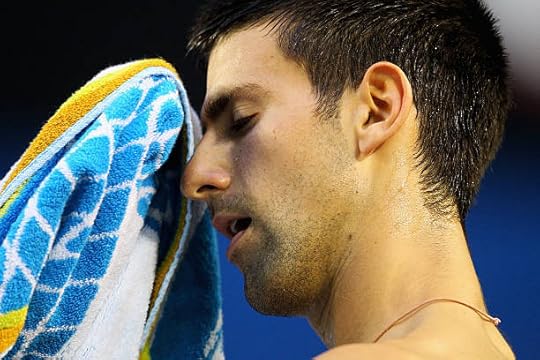 Novak Djokovic of Serbia towels down in his men's final match against Rafael Nadal of Spain during day fourteen of the 2012 Australian Open at...