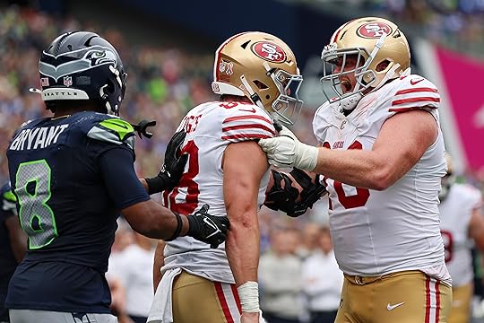 Jake Tonges #88 of the San Francisco 49ers celebrates a...