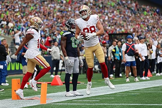 Jake Tonges #88 of the San Francisco 49ers celebrates a...