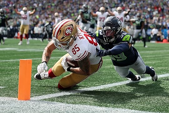 George Kittle #85 of the San Francisco 49ers scores a...