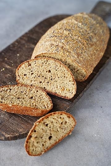 sliced quinoa bread on dark wooden board