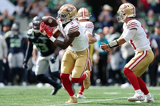 Brian Robinson Jr. #3 of the San Francisco 49ers catches...