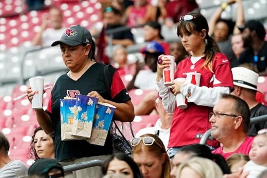 Arizona Cardinals fans walk to their seats during NFL football training camp practice at State Farm Stadium Saturday, July 29, 2023, in Glendale, Ariz. (AP Photo/Ross D. Franklin)