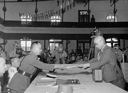 Yasuji Okamura surrendering to He Yingqin, Nanjing, China, 9 September 1945 (US government photo via Wikipedia)