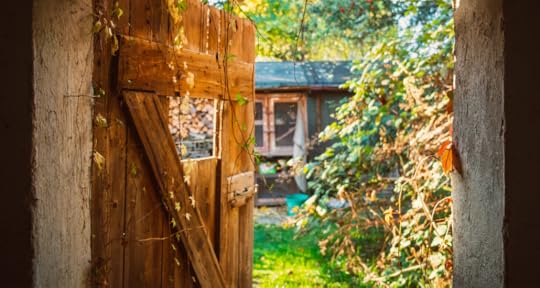 An old door and house but bathed in warm golden light.