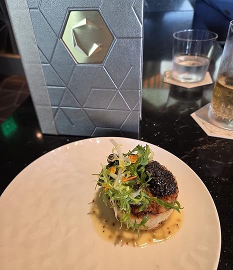 A single beautiful crab cake near a menu at GEO-82