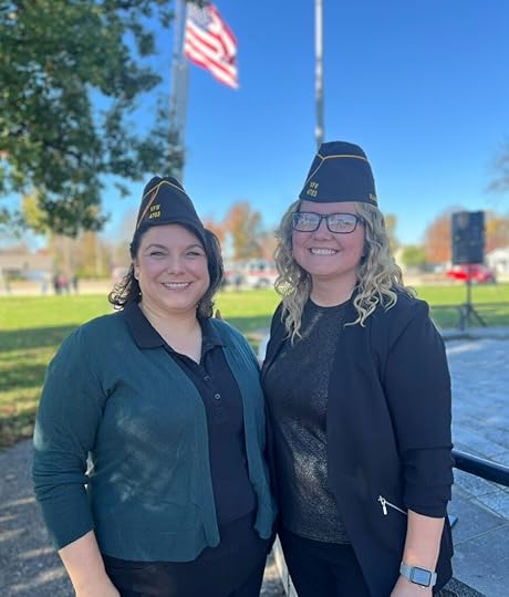 Two female veterans wearing VFW hats