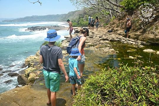 a family crossing the river of catarata el chorro