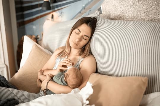 woman feeding baby formula