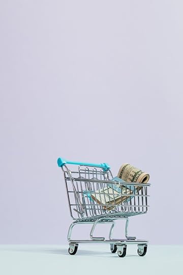 Mini shopping cart filled with rolled cash, symbolizing scientific proof of manifestation and attracting financial abundance