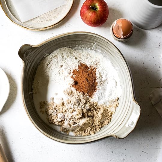 Dry ingredients for the apple cinnamon scones recipe—including flour, sugars, and spices—in a large mixing bowl.