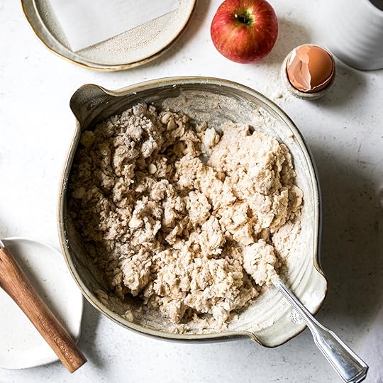 The shaggy scone dough mixture in a mixing bowl after the wet and dry ingredients have been combined.