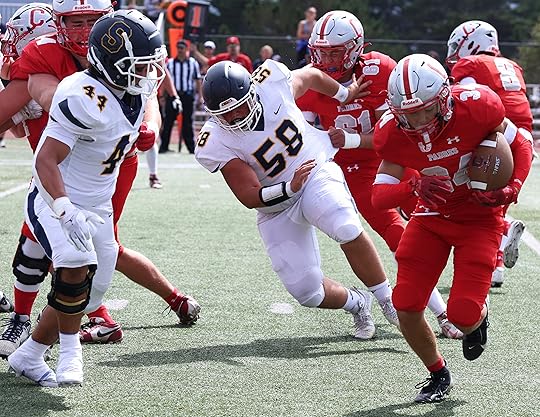 Carmel running back Max Goldsmith gains short yardage in the...