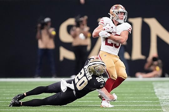 San Francisco 49ers running back Christian McCaffrey, right, catches a...
