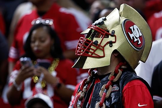 A San Francisco 49ers fan watches during the second half...