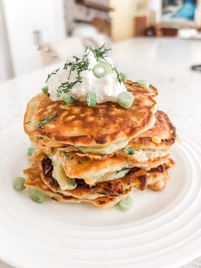The finished Savory Corn and Zucchini Fritters topped with Greek yogurt