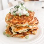 The finished Savory Corn and Zucchini Fritters topped with Greek yogurt