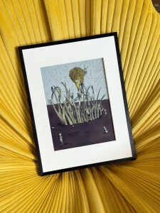 Image of a Bloomin8 color e-ink frame with Companyd displayed in a yellow chair