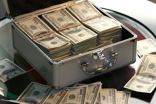 Open silver briefcase filled with stacks of hundred-dollar bills, representing wealth and millionaire mindset secrets.