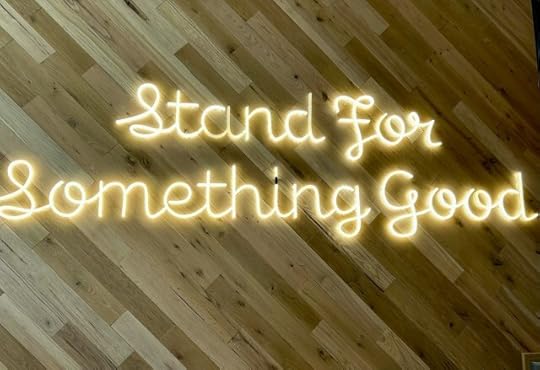 A sign reading “Stand for something good.” Why be for rather than against things?