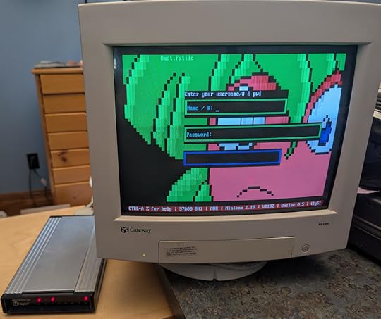 Photo of a color VGA monitor displaying a BBS login screen