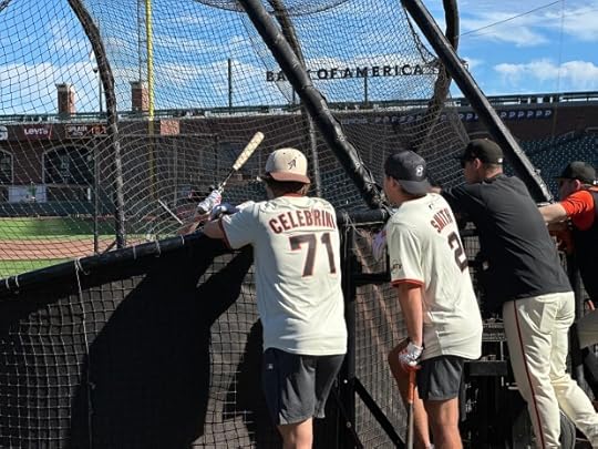 The San Jose Sharks Macklin Celebrini, left, and Will Smith talk to Giants hitting coach behind the batting cage at Oracle Park on Monday, September 8, 2025. (Evan Webeck / Bay Area News Group)
