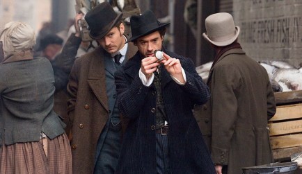 Robert Downey, Jr., as Sherlock Holmes and Jude Law as Dr. Watson walking down a busy street, an example of a Flat Character Arc in which Holmes applies truth through reason and deduction.