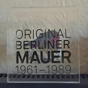 piece of the Berlin Wall in a souvenir plastic mount