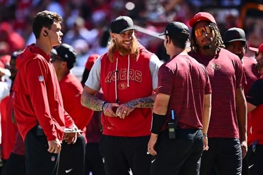 San Francisco 49ers George Kittle (85) smiles while talking to quarterback Brock Purdy (13) on the sideline in the second quarter of their NFL game at Levi's Stadium in Santa Clara, Calif., on Sunday, Sept. 21, 2025. (Jose Carlos Fajardo/Bay Area News Group)