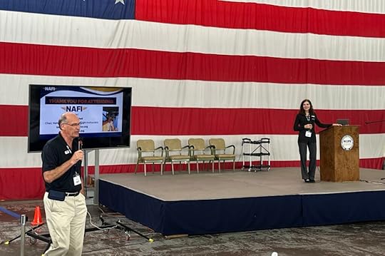 NAFI's Paul Preidecker and Karen Kalishek give closing remarks at the NAFI Summit 2025 in Ohio. Paul stands to the left of the stage and Karen is on it.