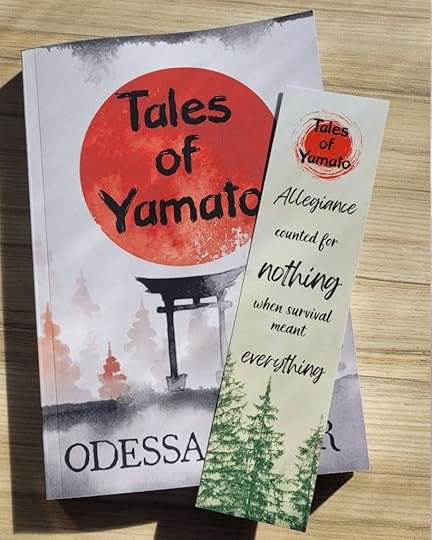 The book Tales of Yamato sits on a background of wood grain. On top of the book is a bookmark with the text